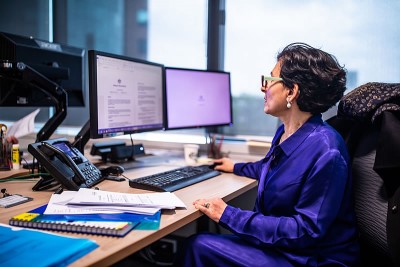 A woman sitting at a desk with a computer