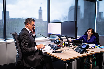 A man at a desk with a phone