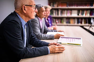 Two men and a woman at a desk
