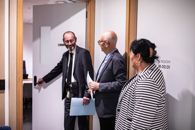 A man holds a door open